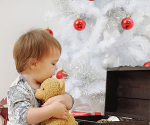 portrait of cute little baby girl playing with Christmas toys
